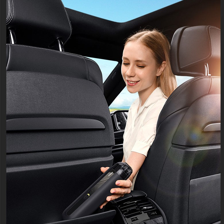 Woman cleaning car interior with a vacuum cleaner