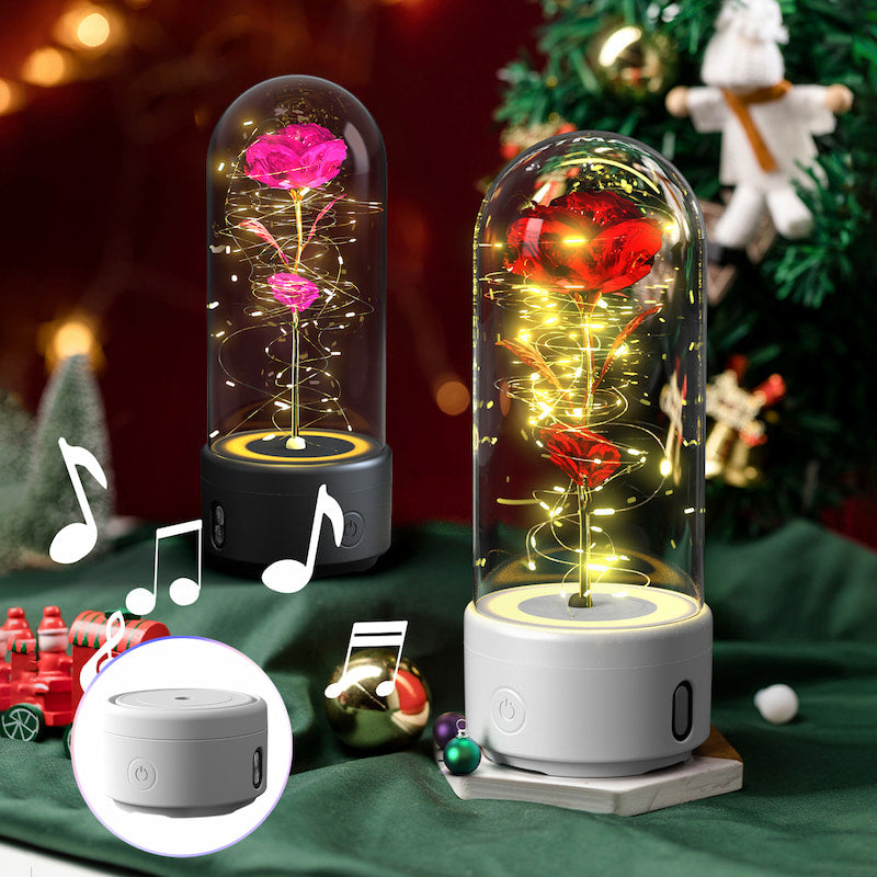 Decorative lamp with LED lights and roses inside a glass dome on a festive background.