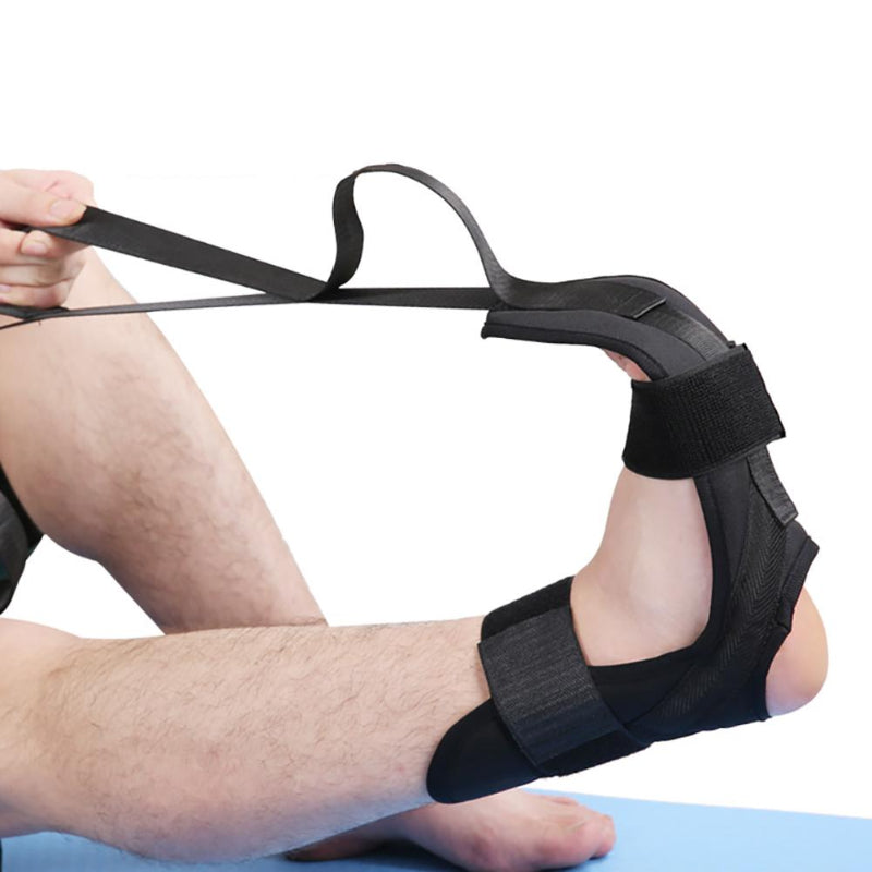 Person using a black ankle support brace with a white background