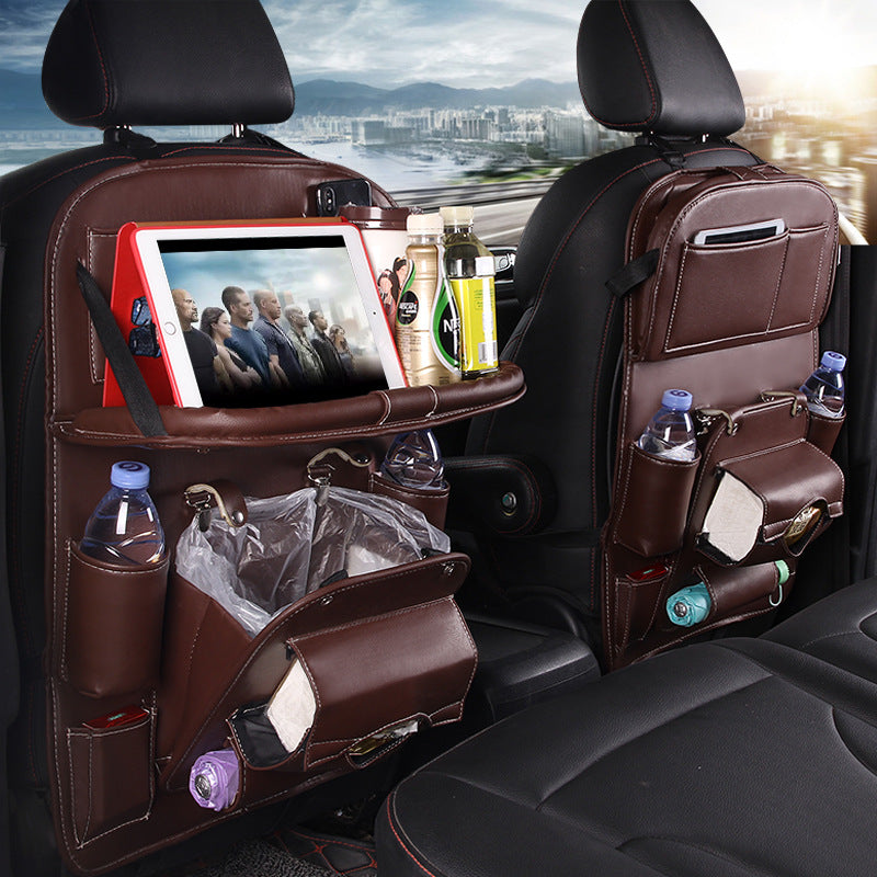 Car back seat organizer with multiple pockets and a tablet holder, cityscape in the background