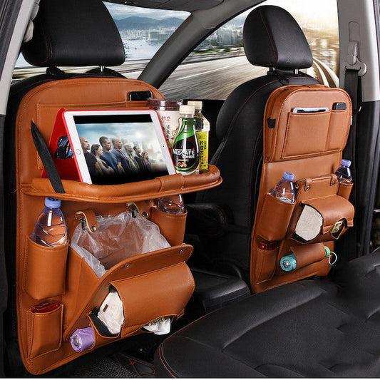 Car back seat organizer with multiple pockets and a tablet holder, filled with items.