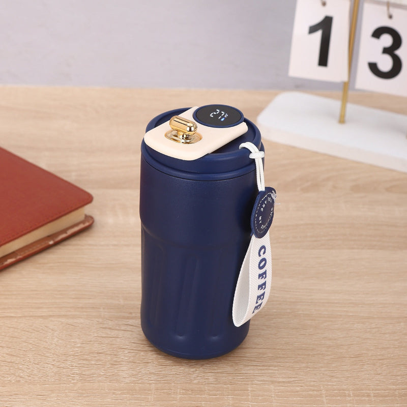Blue thermos with a white label on a wooden surface