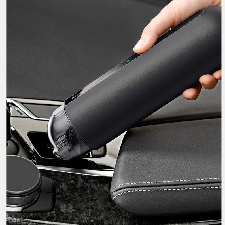 Person using a black car detailing tool on a car seat