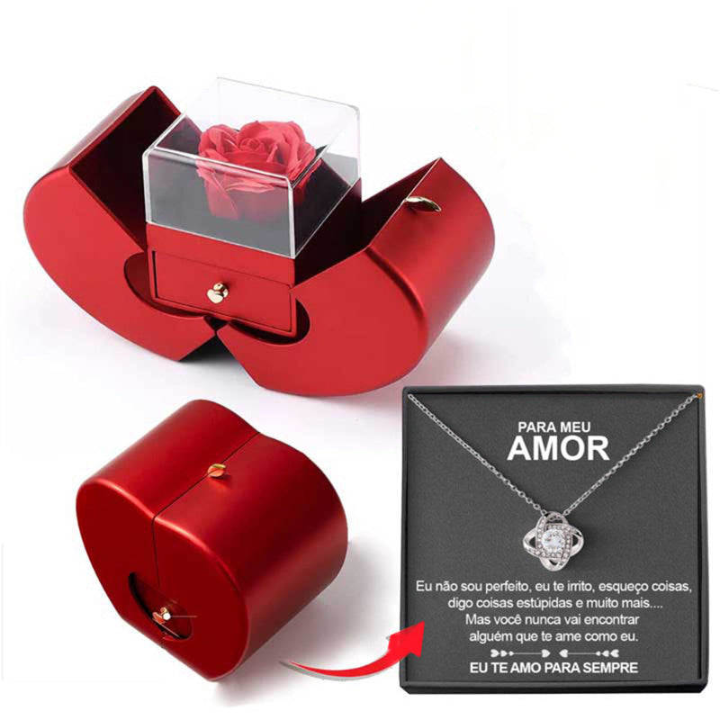 Red jewelry box with a rose and a necklace with a heart pendant on a white background