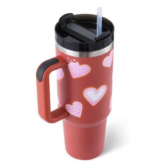 Red travel mug with heart patterns on a white background