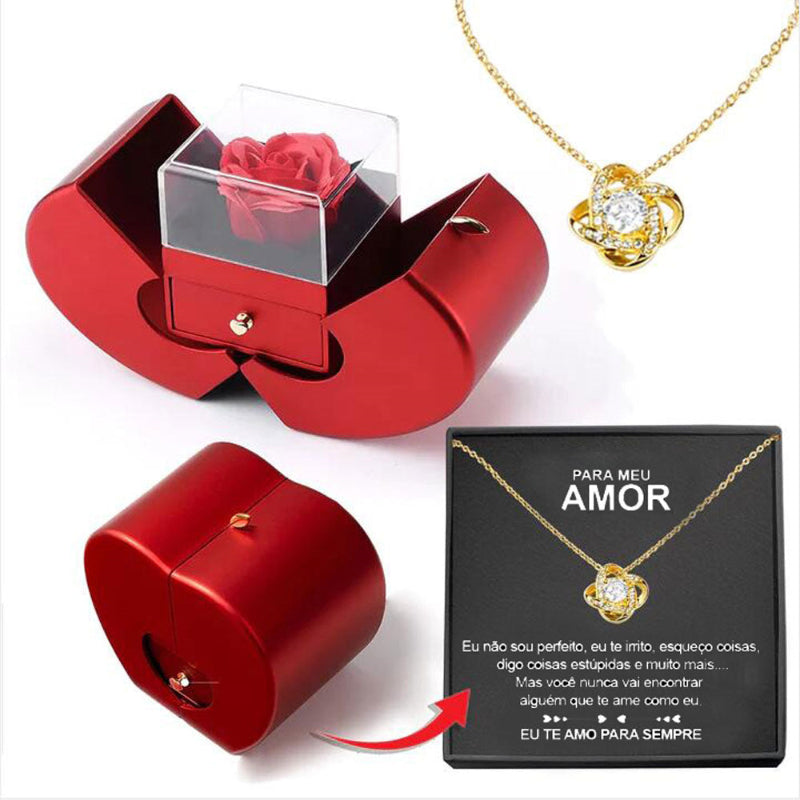 Red jewelry box with a rose, gold necklace with heart pendant, and 'Para Meu Amor' card on a white background.