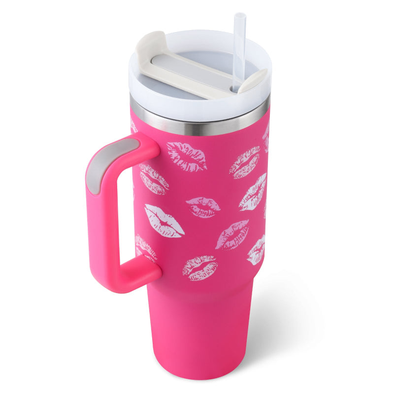 Pink tumbler with lip print design on a white background