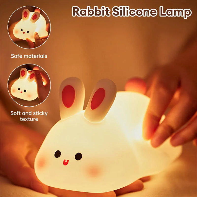 Rabbit silicone lamp with glowing effect, safe materials, soft and sticky texture text, and a hand holding it.