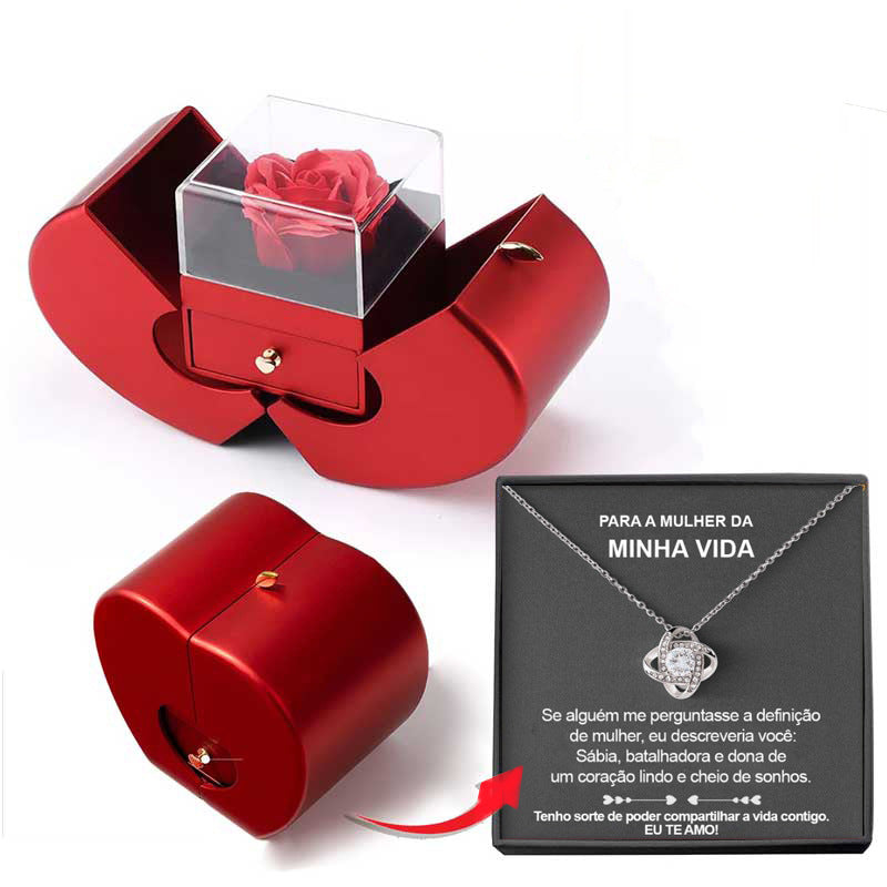 Red jewelry box with a rose and a necklace with a heart pendant on a white background