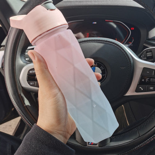Hand holding a pink and white umbrella inside a car