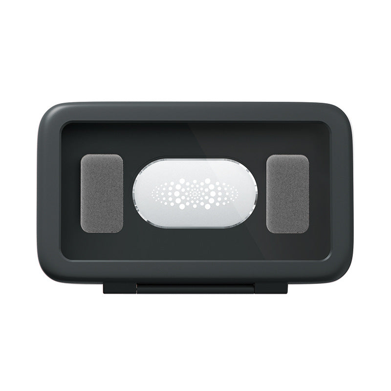 Black electronic device with a white circular component on a white background