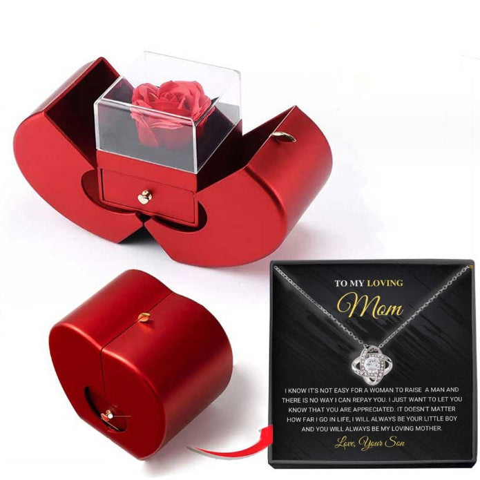 Red jewelry box with a rose and a card for a mother on a white background