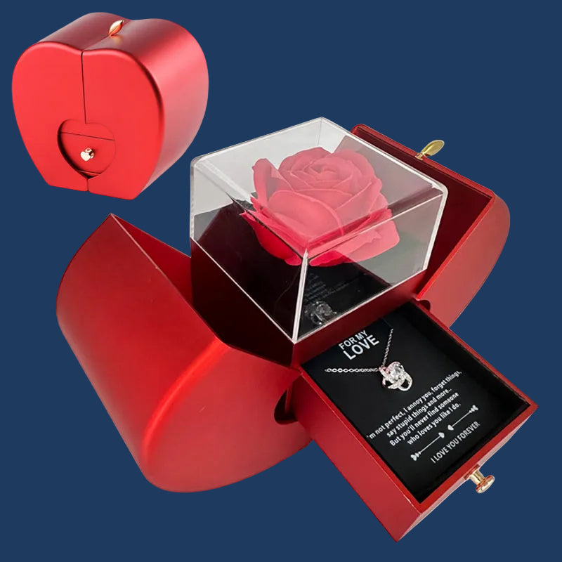 Red heart-shaped box with a rose and necklace on a blue background