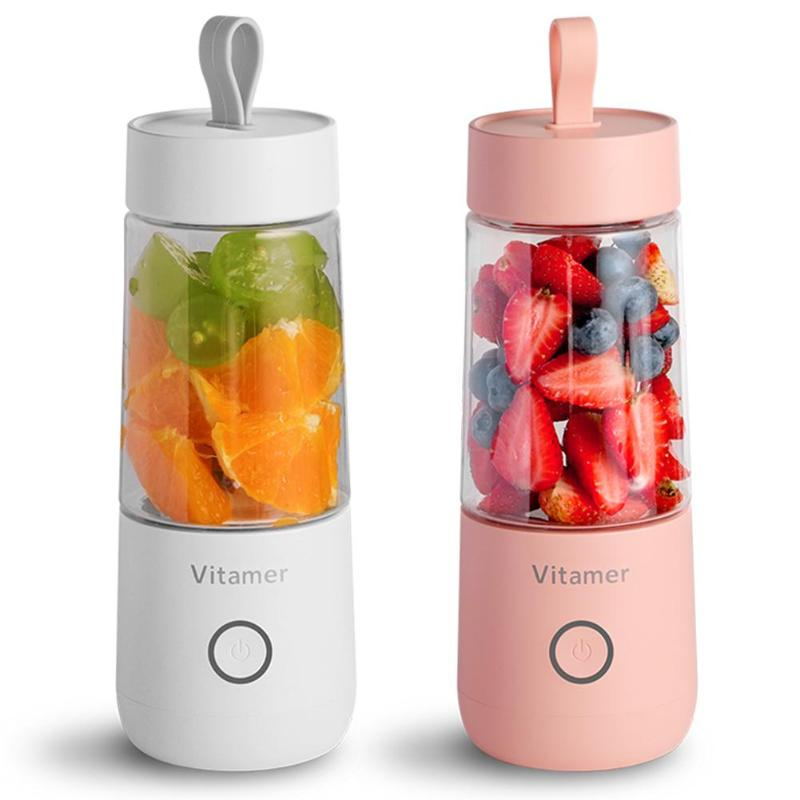 Two portable blenders with fruits inside, one white and one pink, on a white background.